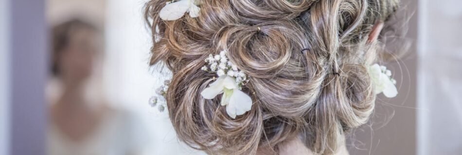 Close-up of an elegant bridal hairstyle featuring delicate white flowers, perfect for a wedding day.